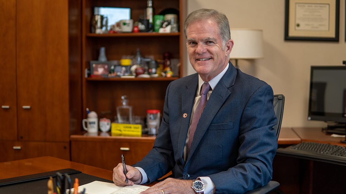 Dean Jeff Bauer sitting at his desk