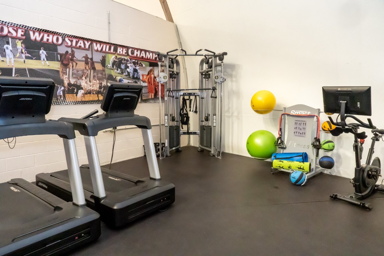 treadmills, resistance bands and an elliptical in the fitness area